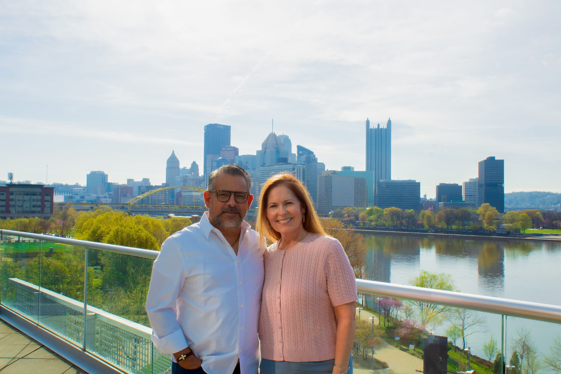 Julie and Isaac, the hosts, with the Pittsburgh skyline behind them